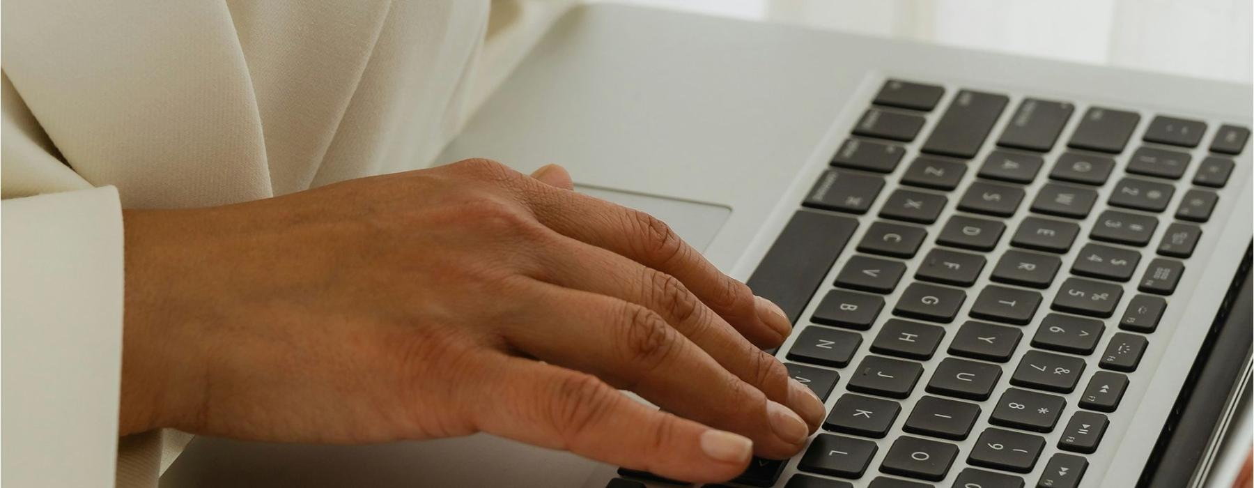 a person typing on a laptop