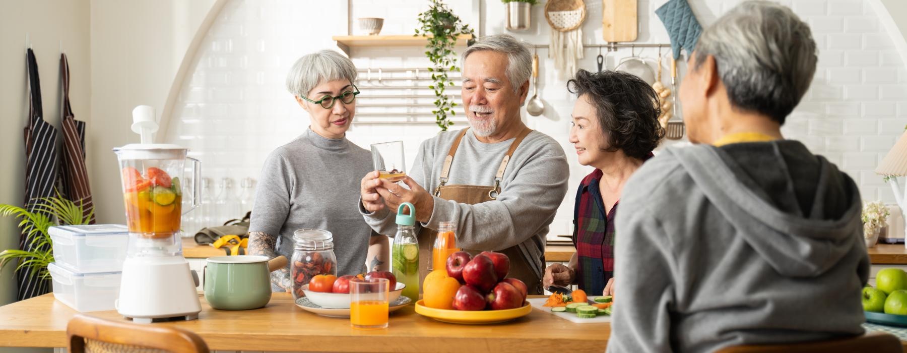 Residents making juice at Encore at Bishop Heights senior living apartments in Lincoln, NE, featuring natural lighting.