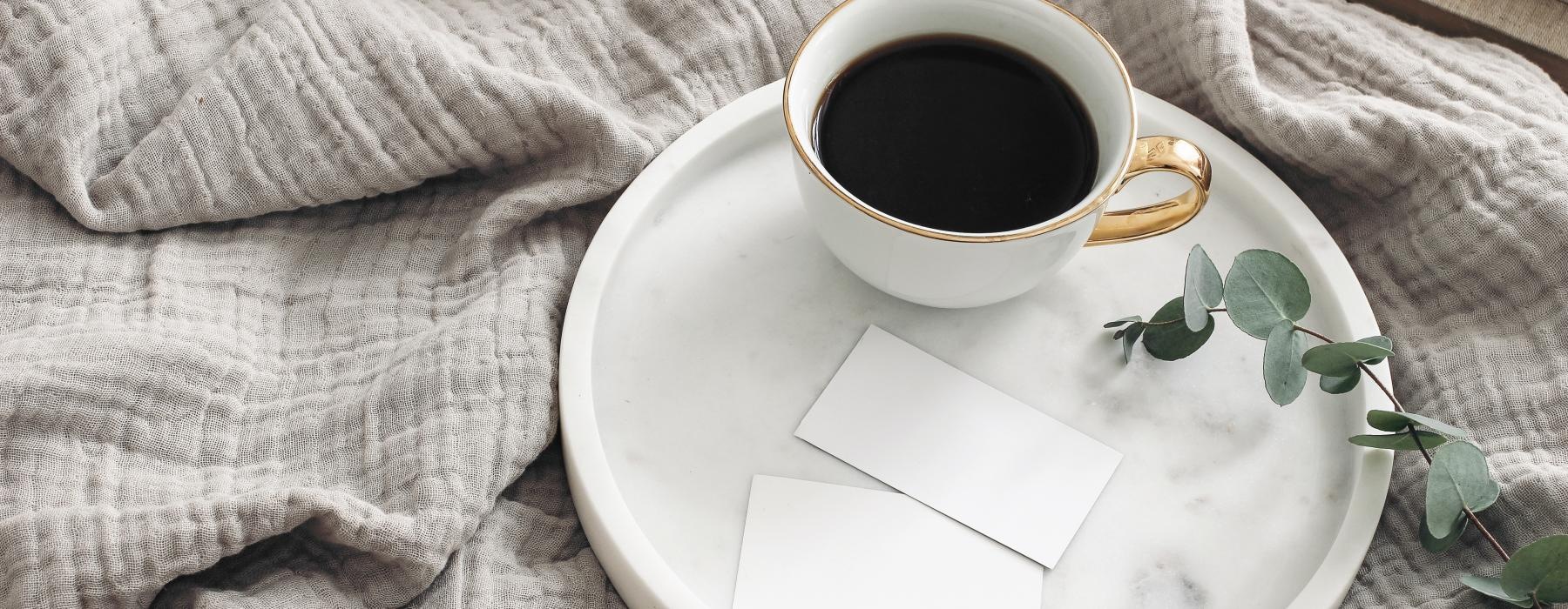 a cup of coffee on a saucer on a couch